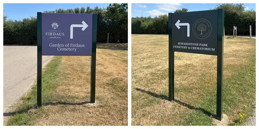 Custom branded post and panel directional signage guiding visitors along a pathway at Sewardstone Cemetery.